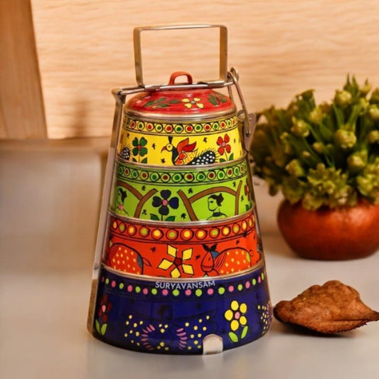 A hand-painted 4 tier steel tiffin box with multicolor designs, displayed on a table.