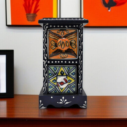 Decorative ceramic piece with geometric patterns on a wooden surface