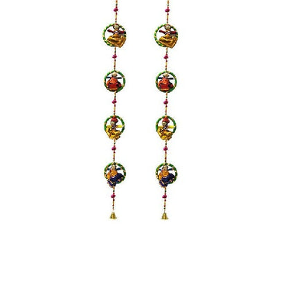 A pair of wooden Ganesha hanging door decorations with intricate detailing and colorful embellishments.