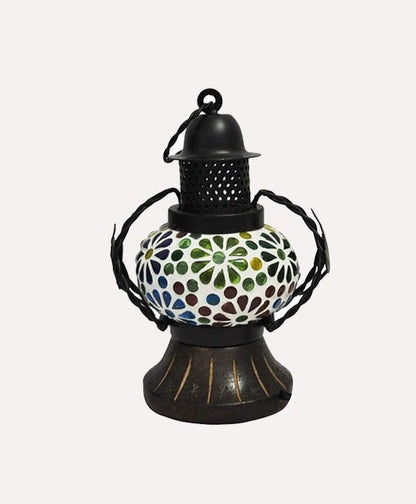 A handcrafted wooden lantern with a multicolored patterned glass panel and a black metal chimney, designed for indoor hanging