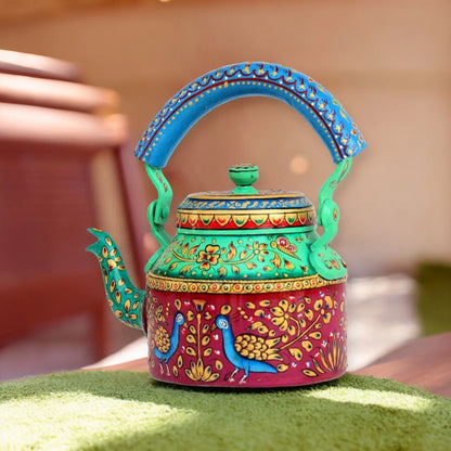 A colorful hand-painted aluminum tea kettle figurine with a wooden handle, featuring floral and animal patterns.