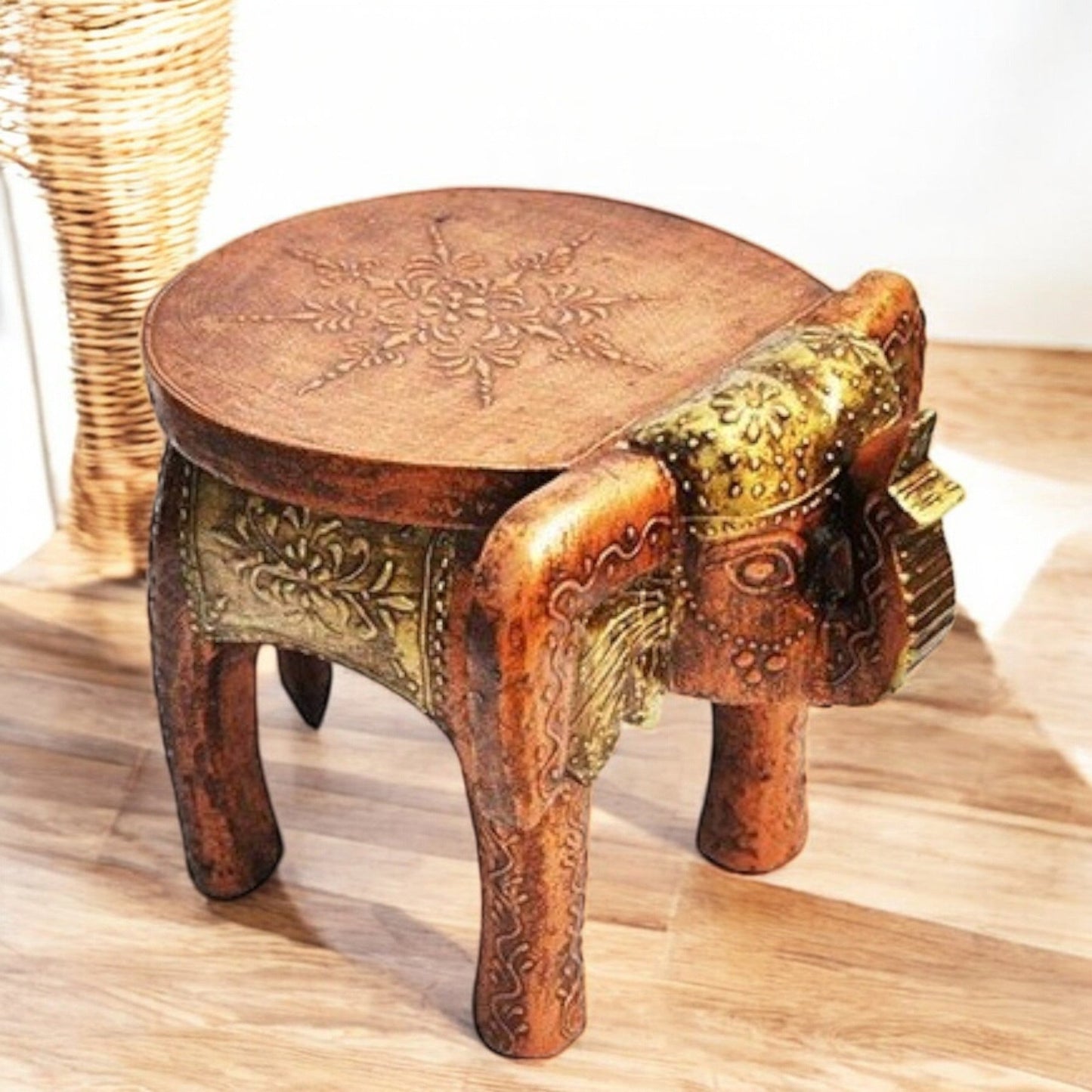 A wooden elephant-shaped side table with intricate designs and a round top.