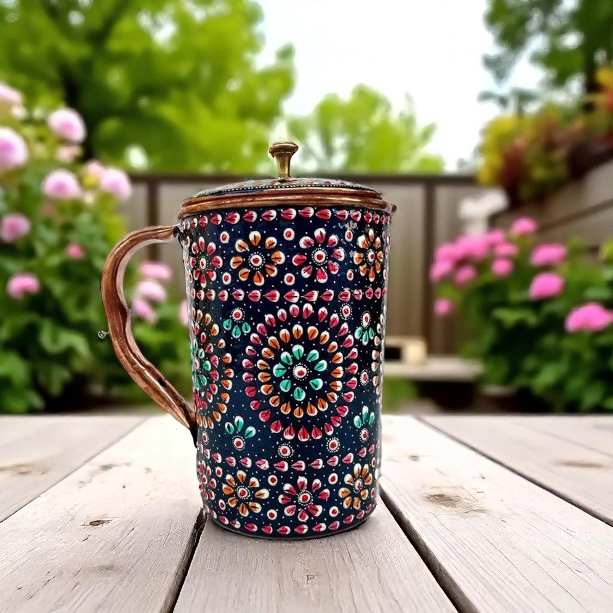 Decorative mug with floral pattern on a wooden table outdoors