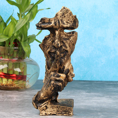 A gold Polyresin thinking man showpiece in a contemplative pose, displayed against a blue background.