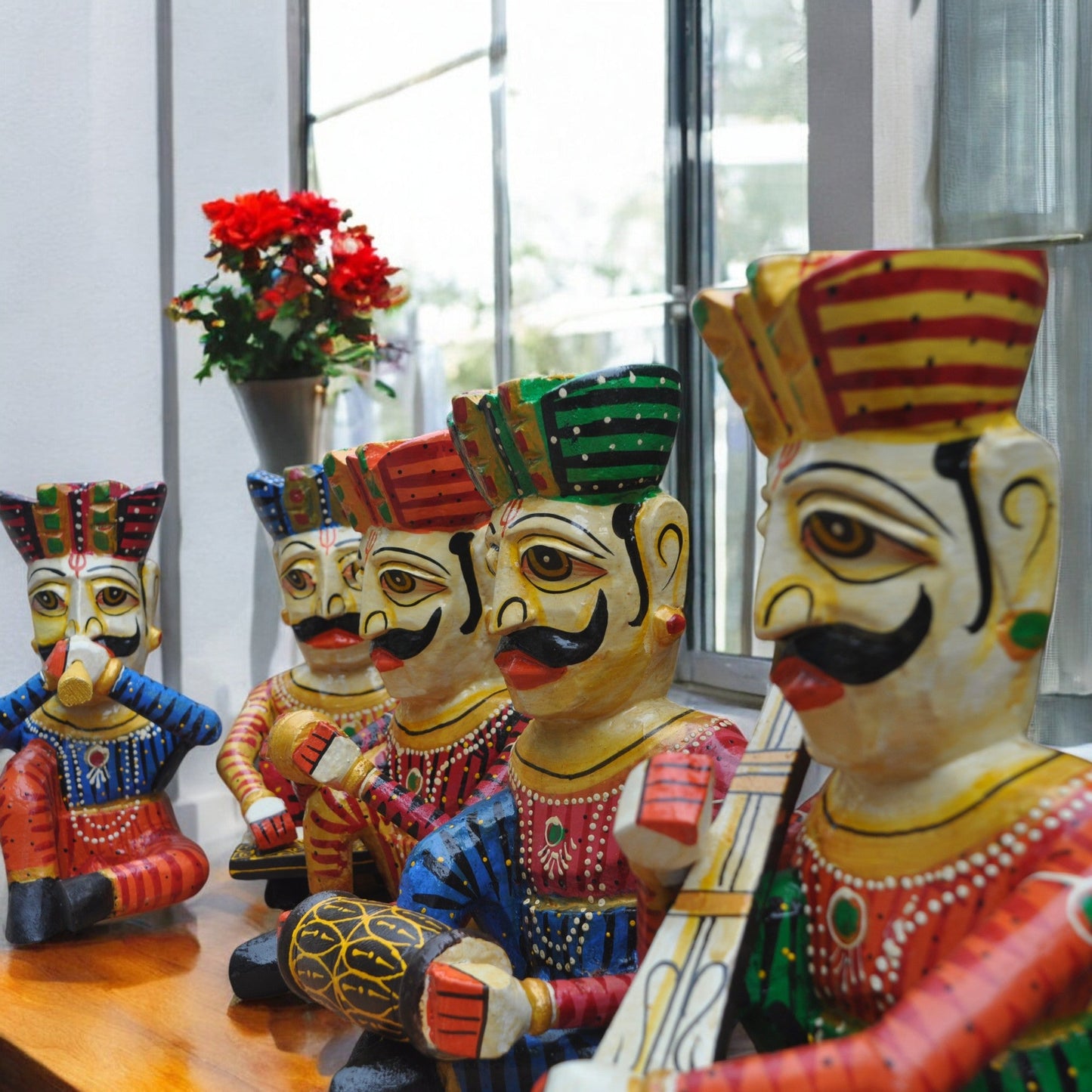 Colorful figurines with intricate designs on a wooden surface.