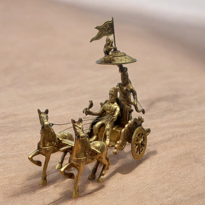 Bronze chariot with horses and figures on a beige background