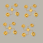 Set of gold earrings on a gray background