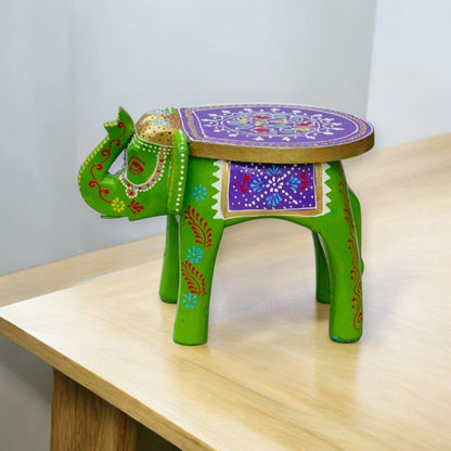 A colorful wooden elephant-shaped side table with intricate patterns and designs.